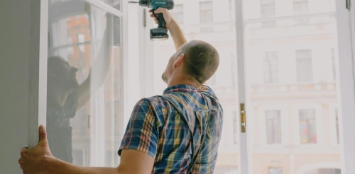Bidmii contractor installing a window.
