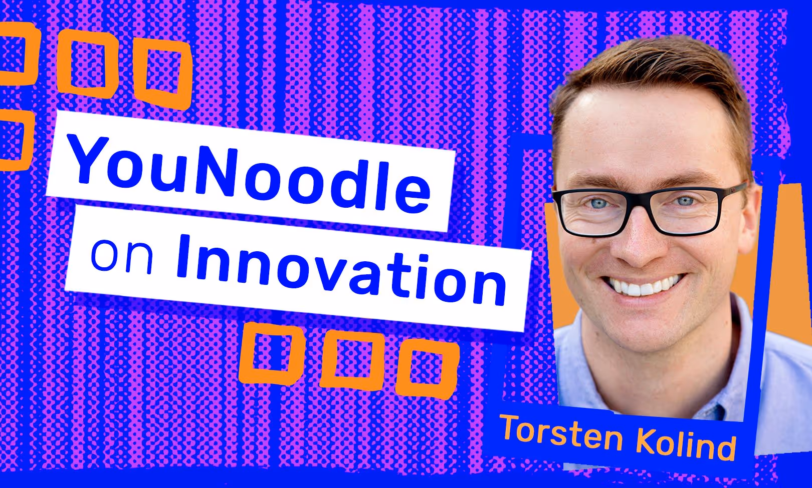 A man with glasses is smiling for the camera