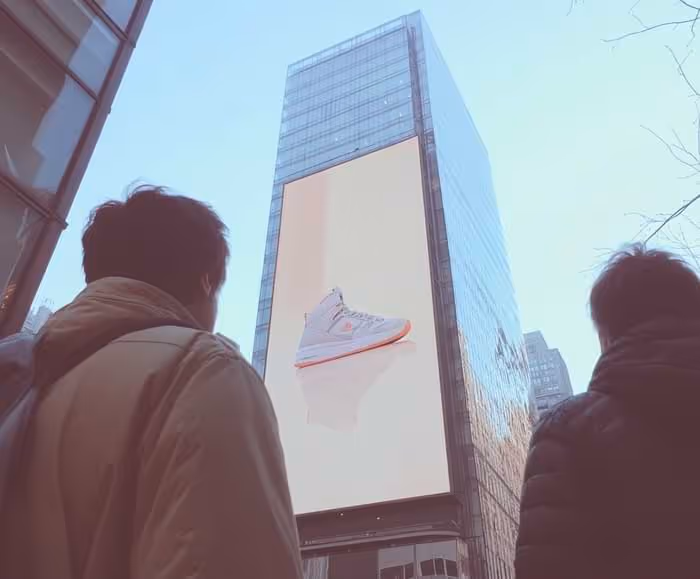 illustration of people looking up at a big sneaker ad on a skyscraper