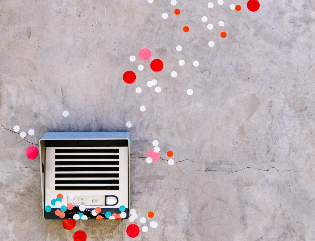 A wall mounted air conditioner sitting on top of a cement wall