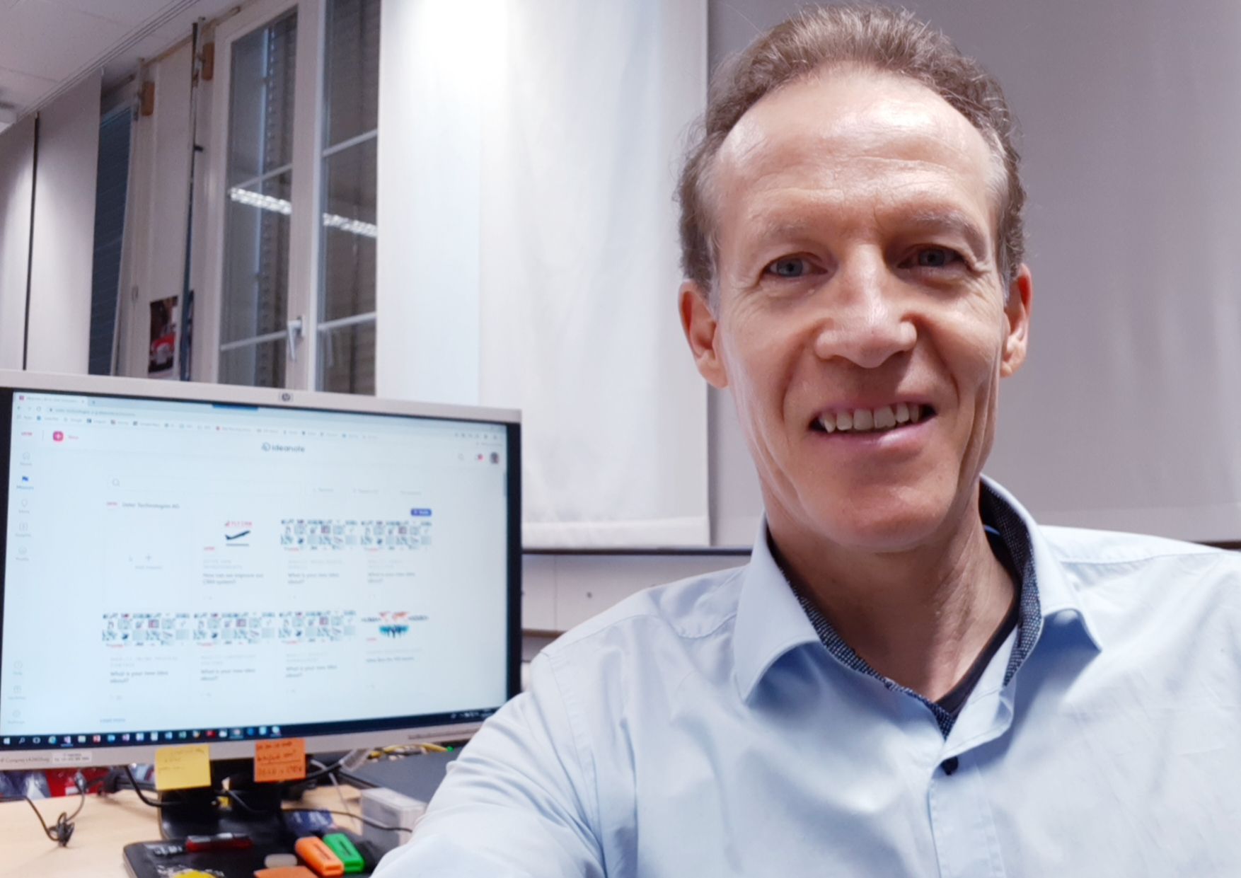 a man in front of computer monitor