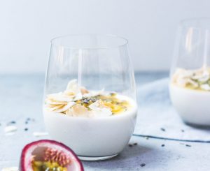 A couple of glasses filled with food on top of a table