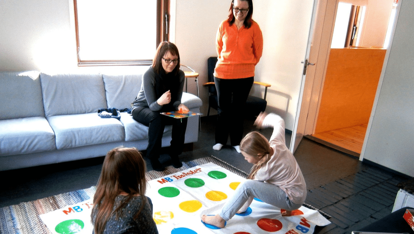 A group of people sitting around a living room