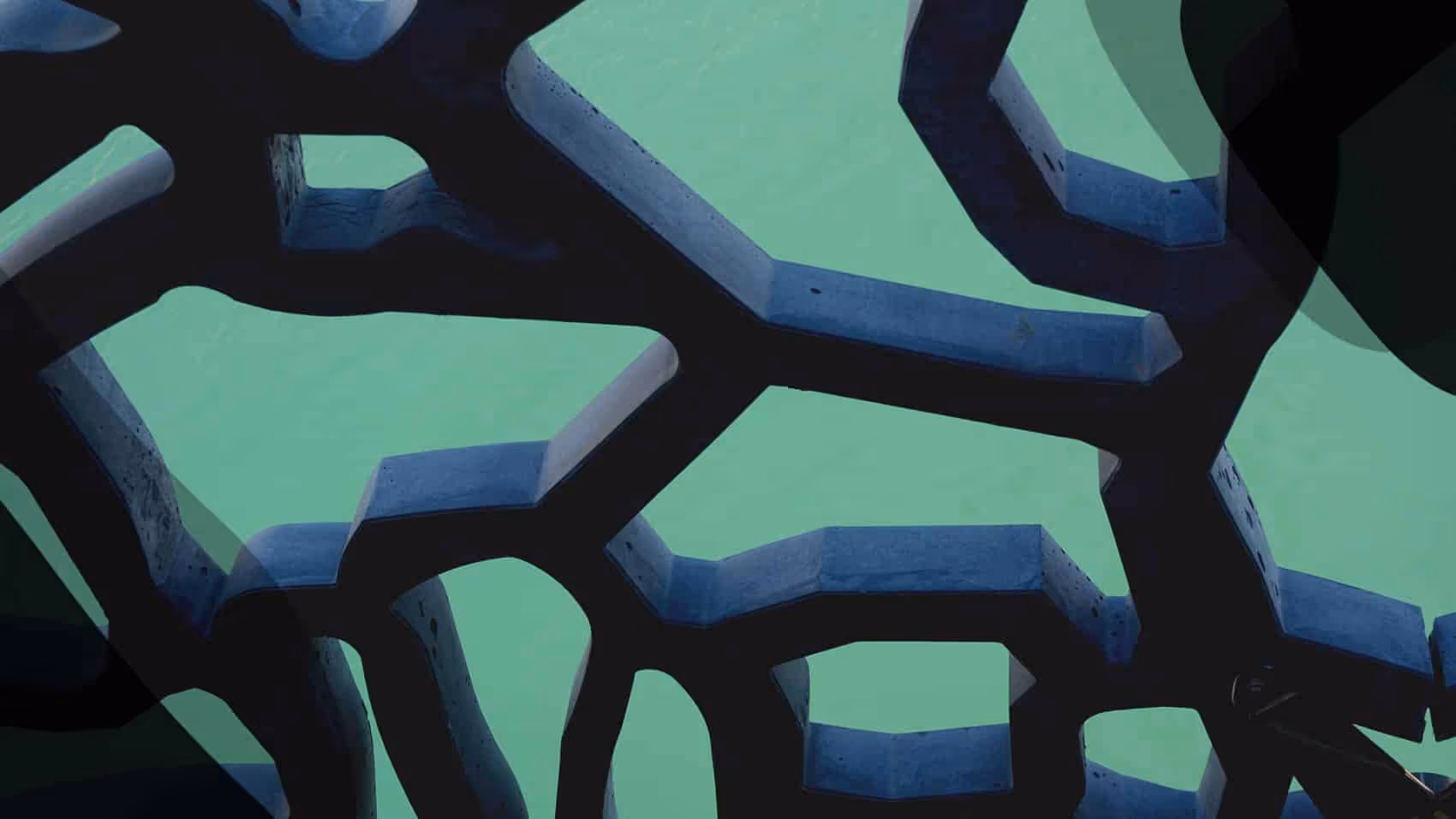 A close up of a painting of blue and green shapes