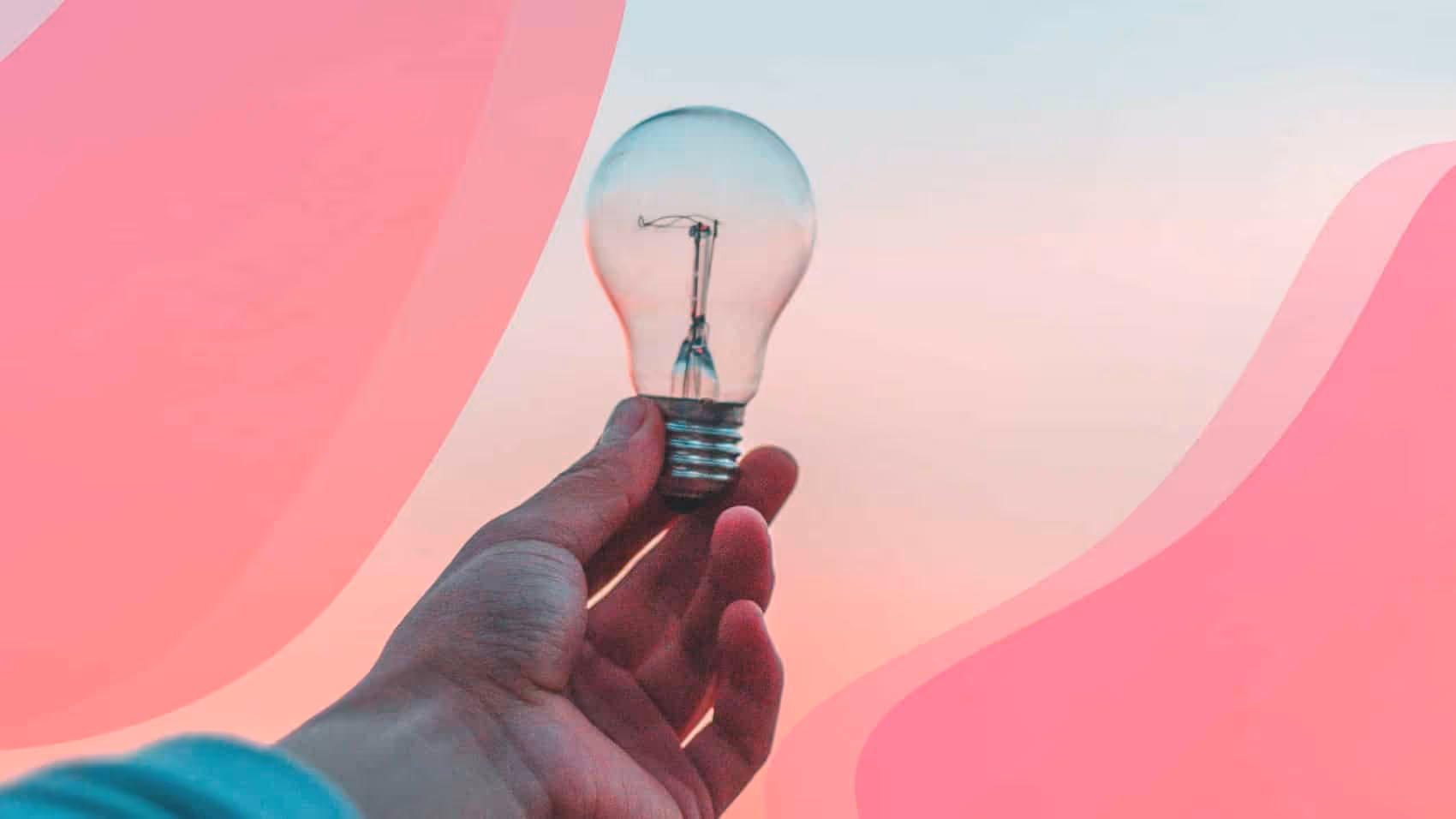 A person holding a light bulb in their hand