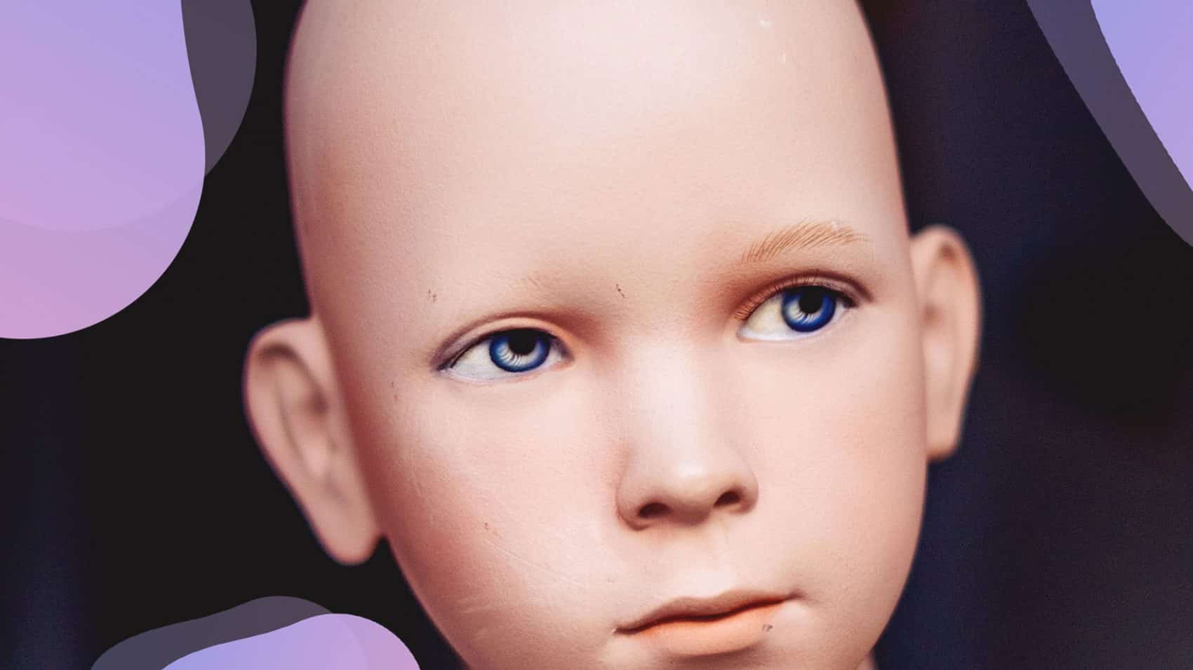 A close up of a mannequin's head with blue eyes