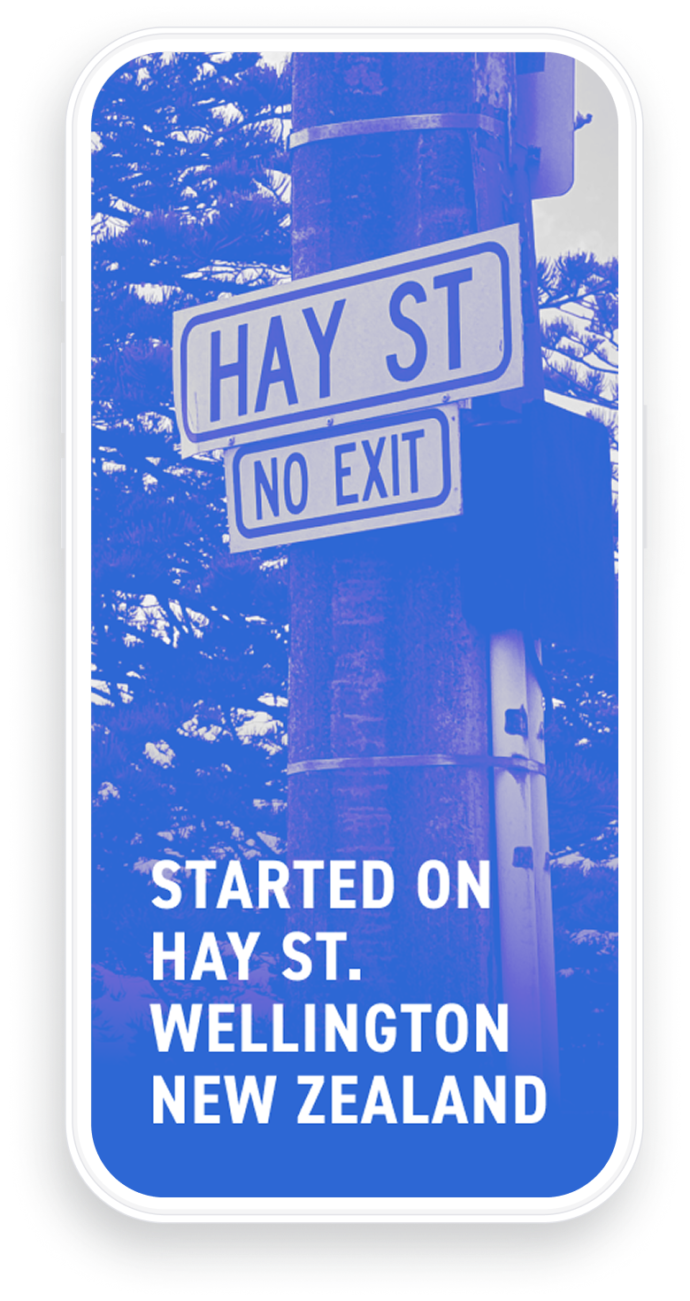 Street signs on a pole showing 'HAY ST' and 'NO EXIT' with trees in the background, overlaid with text reading 'STARTED ON HAY ST. WELLINGTON NEW ZEALAND'.