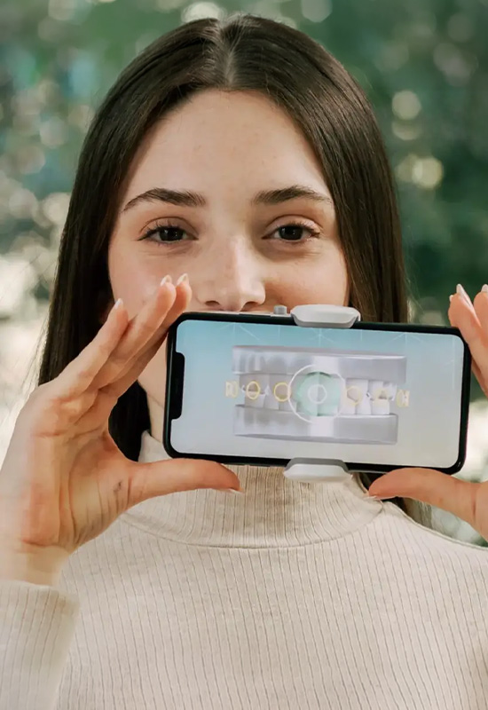 a woman using remote dental monitoring device