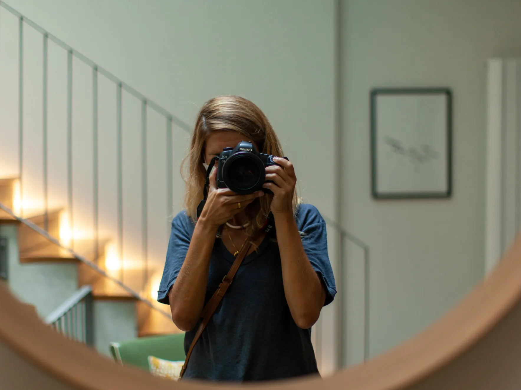 Joana taking a photo in the mirror at Canto de Luz, a boutique guesthouse in downtown Porto