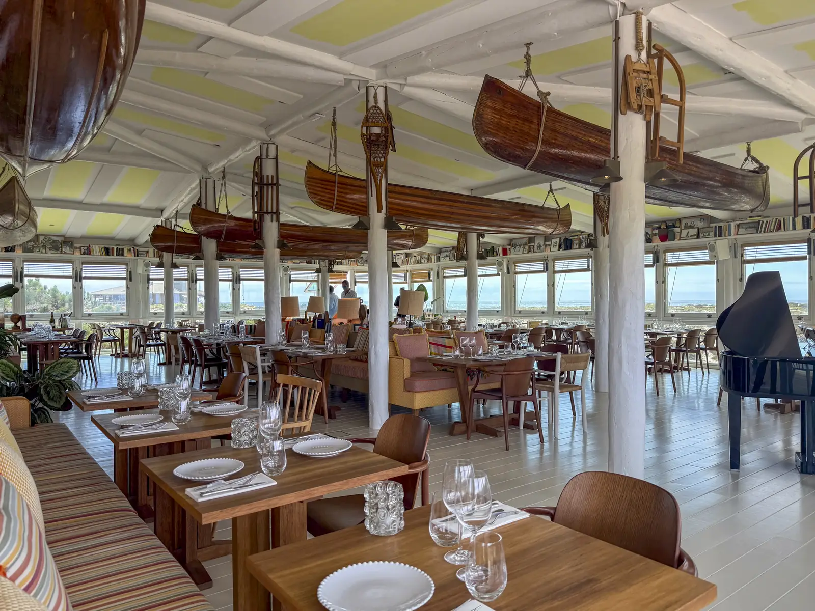 Inside Caché Comporta, with canoes hanging from the ceiling