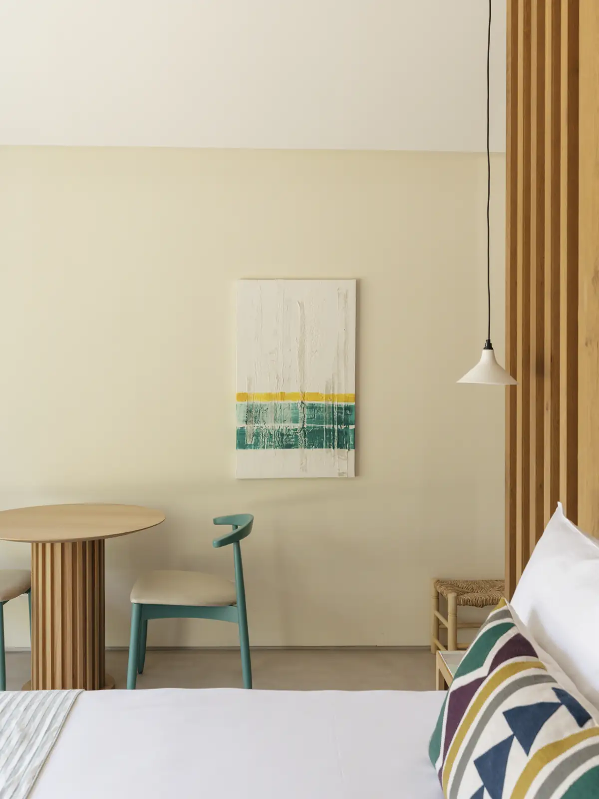 Bed and small table at Spatia Comporta, a five-star hotel retreat.