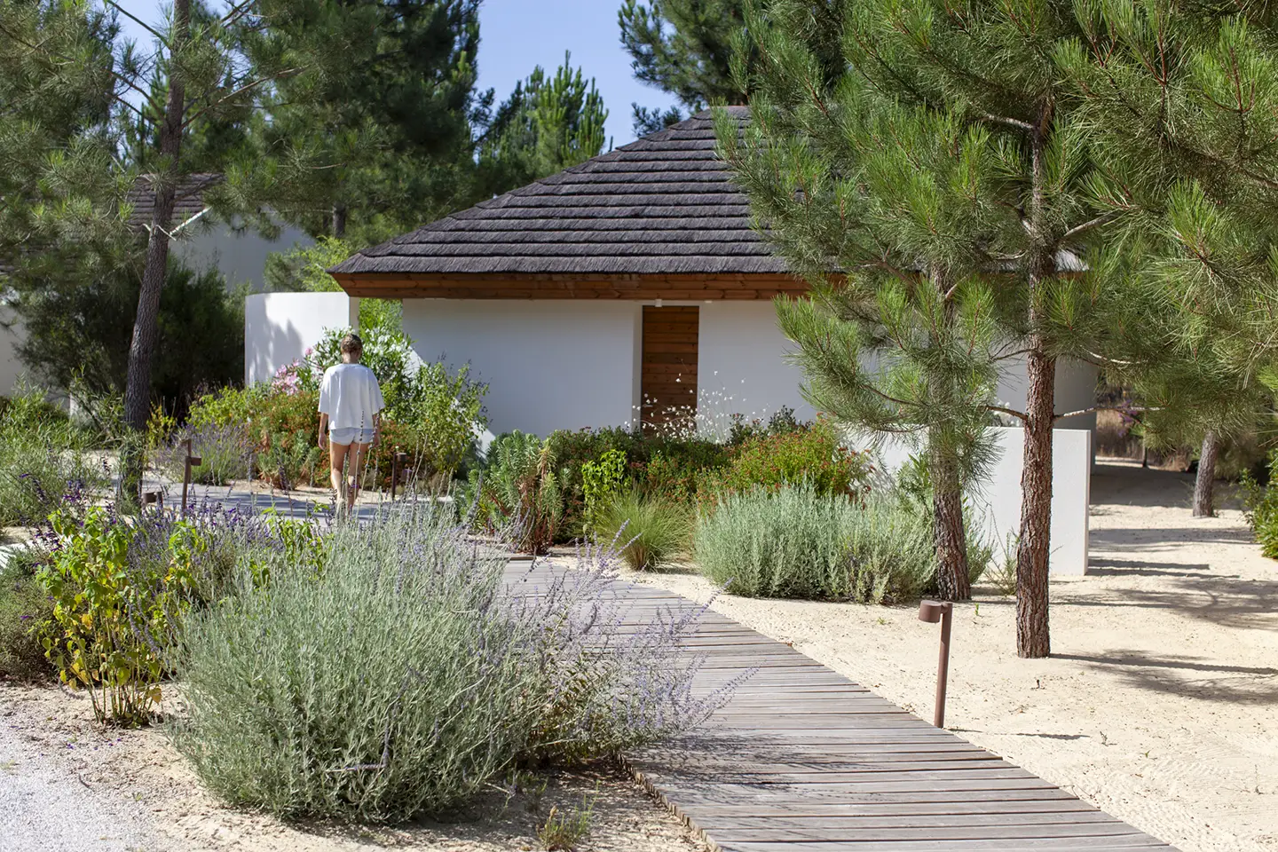Sofia waking towards a Cabana at Spatia Comporta, on of the best hotels in the region.