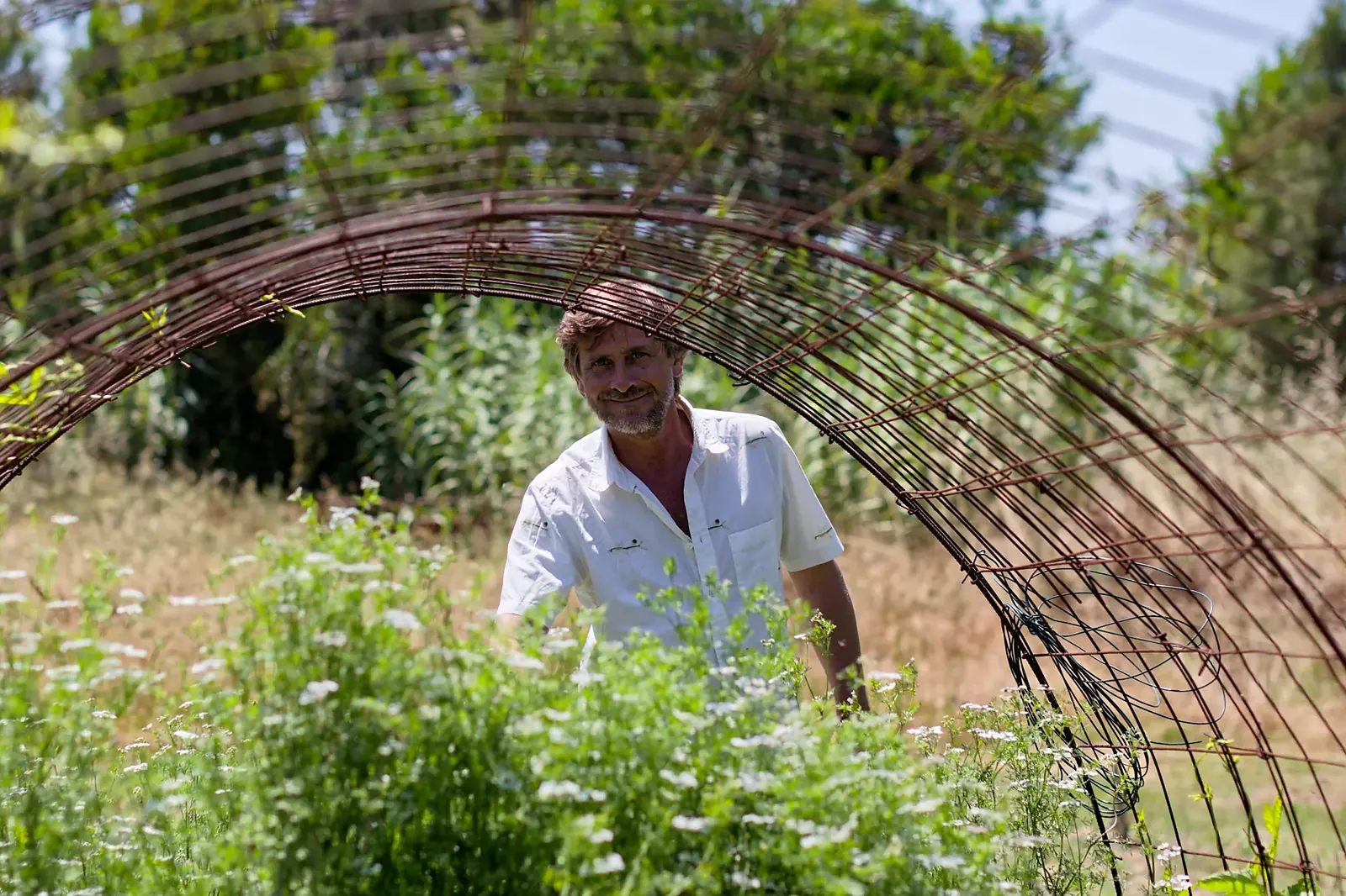 Nuno Avillez Oliveira under a rebar arch in the kitchen garden at Amaria