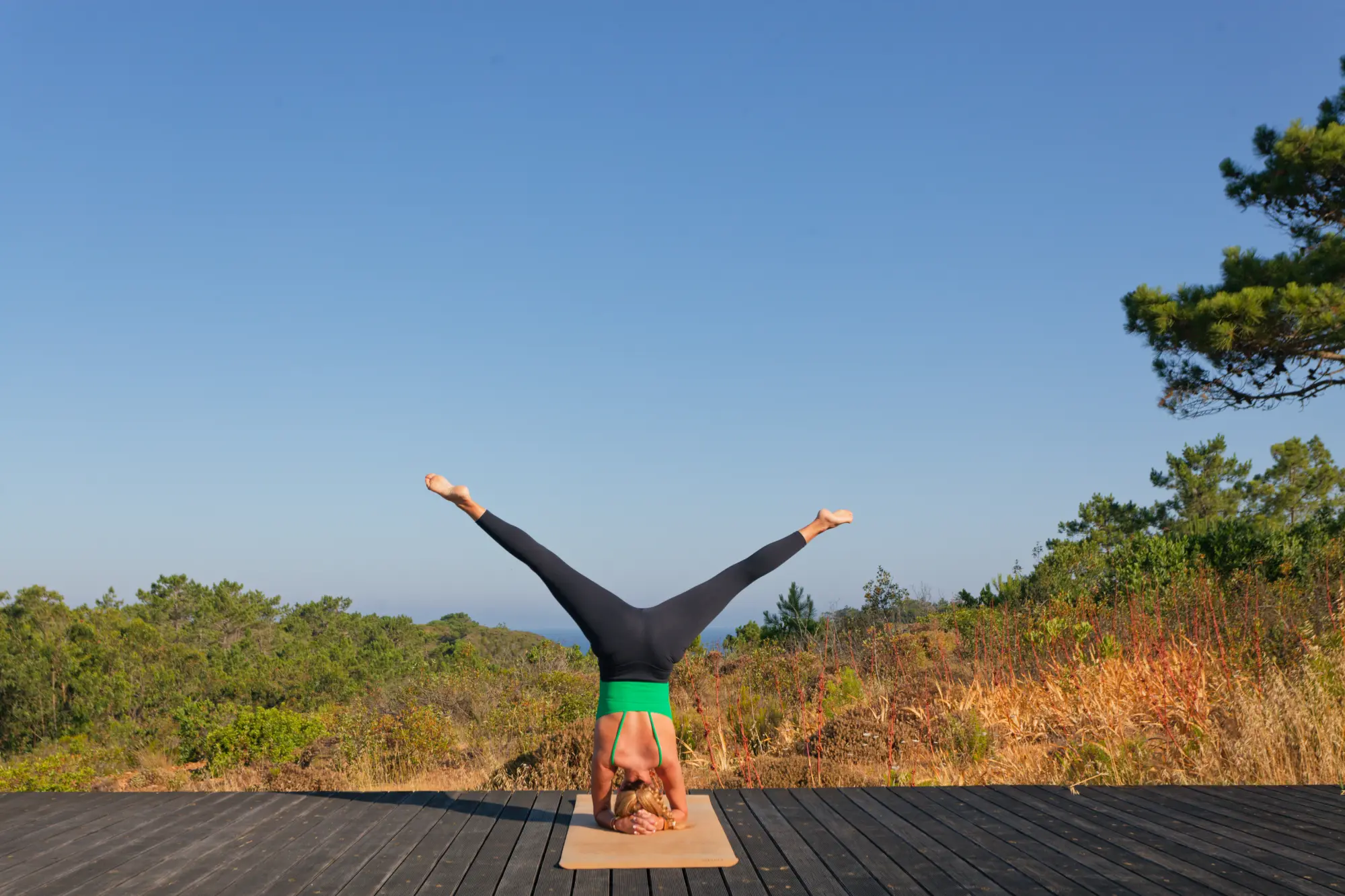 Headstand on the outdoor yoga deck at Amaria, Costa Vicentina