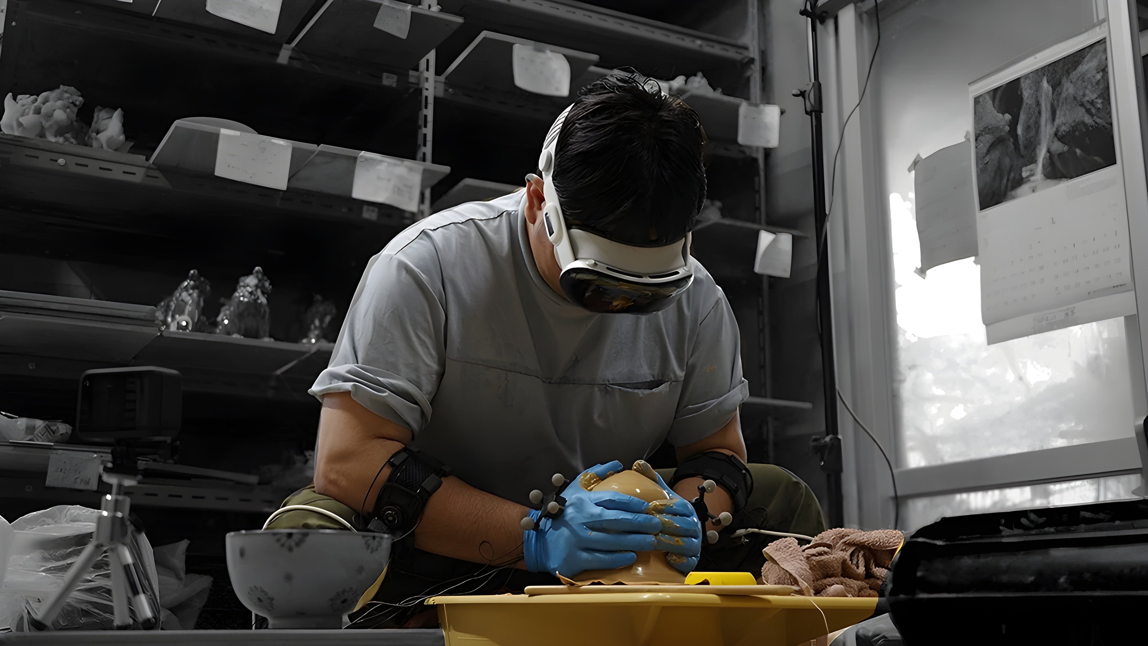 A researcher recording pottery-making using a headset and wearable hand and arm sensors