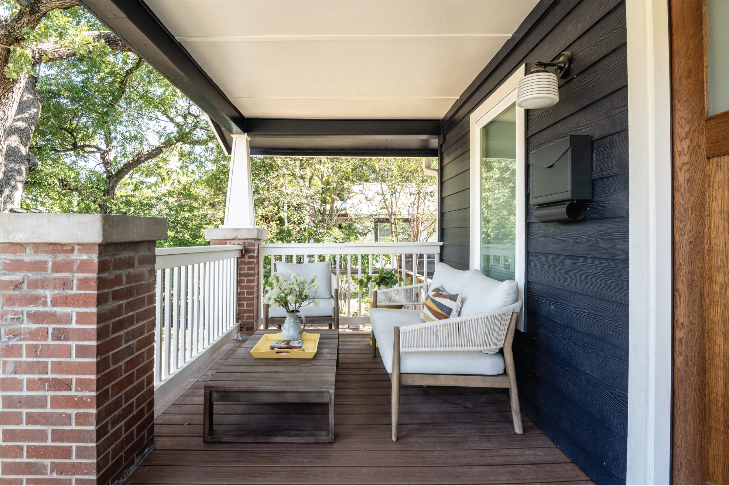 Front Porch with Cushions, Table, and Brick Pillar