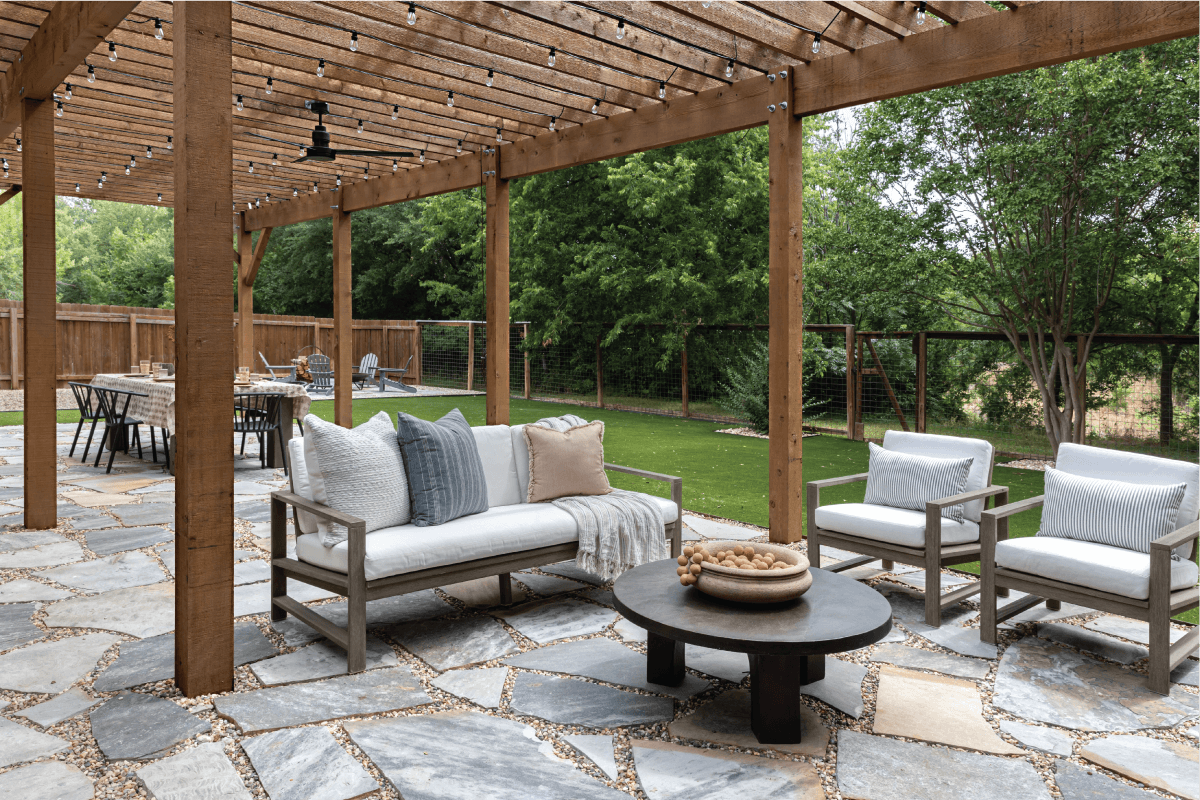 flagstone patio with a large wooden pergola