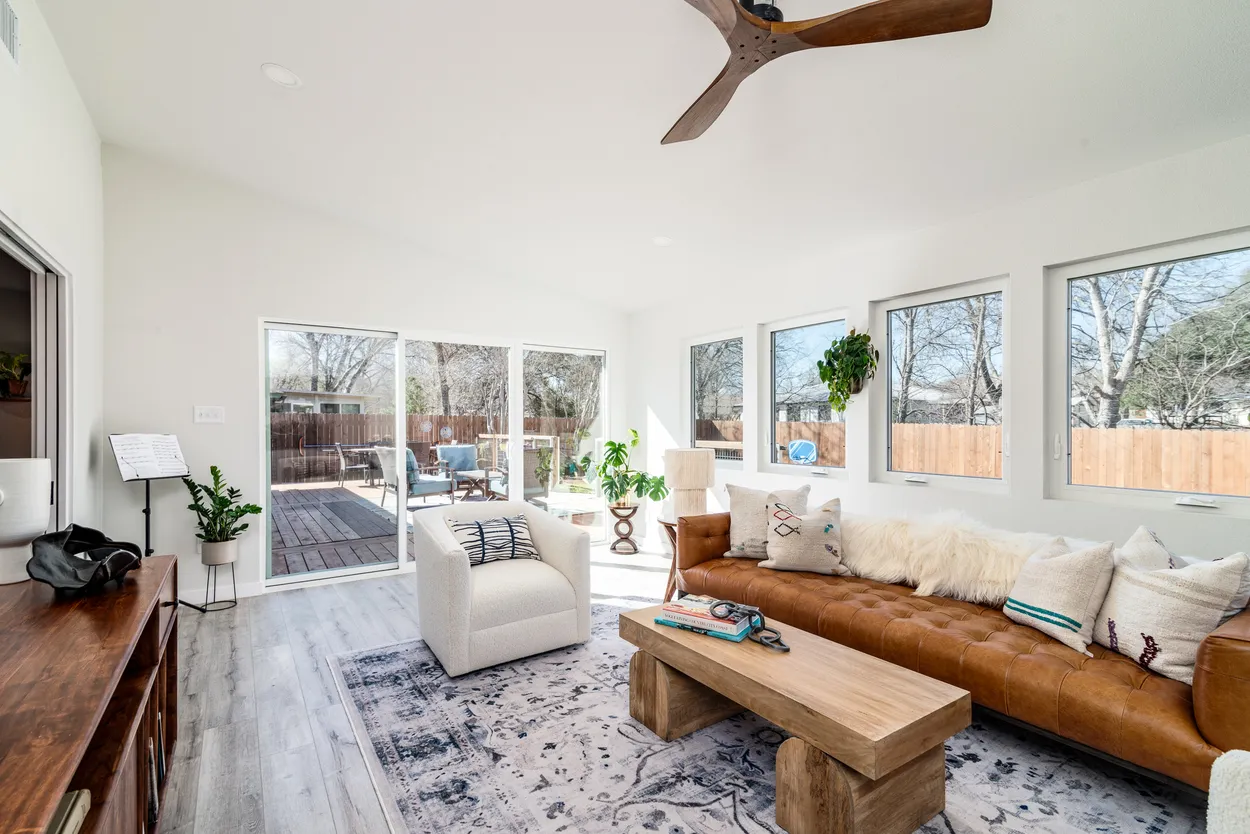 Bright Living Room with Brown Leather Sofa and White Armchair