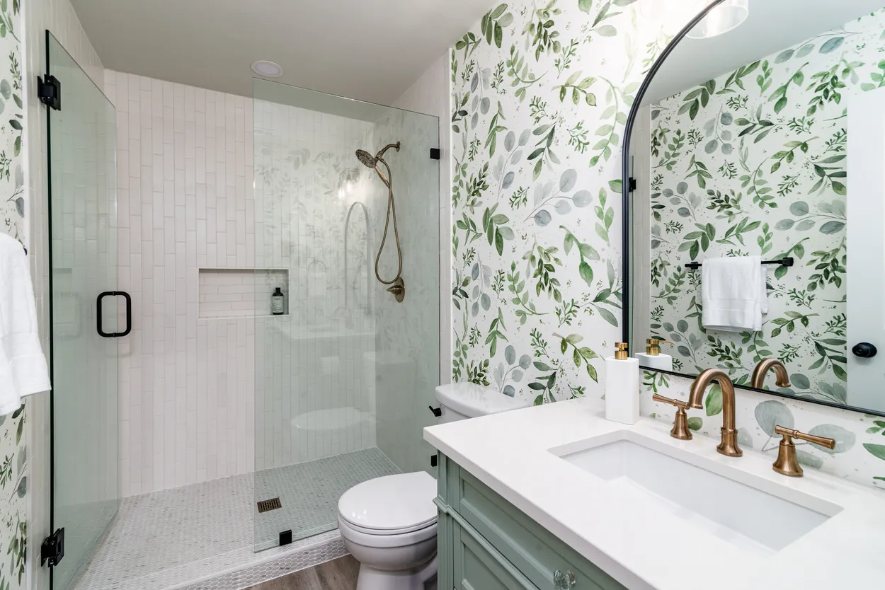 Modern Bathroom with Walk-In Shower, Light Green Vanity, and Gold Fixtures