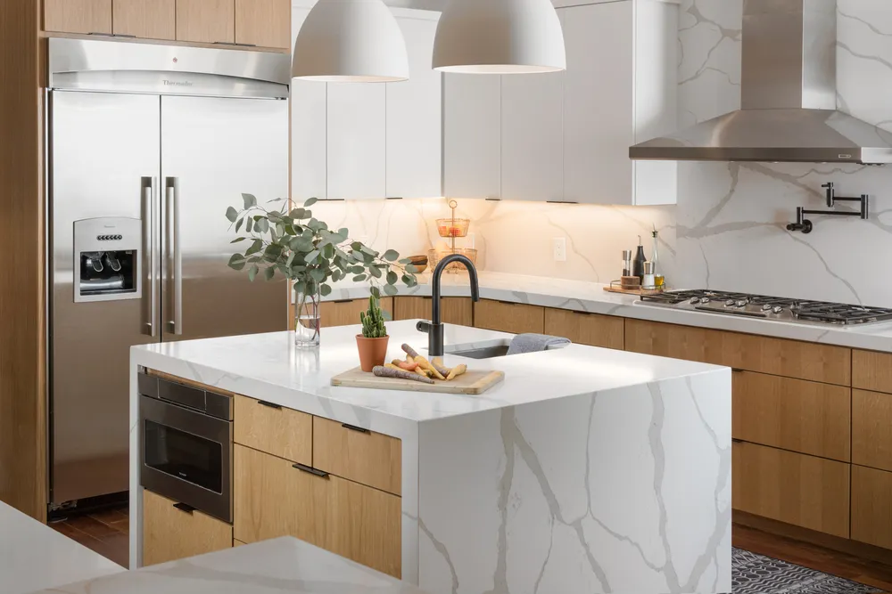 White Marble Island With Sink and Black Faucet