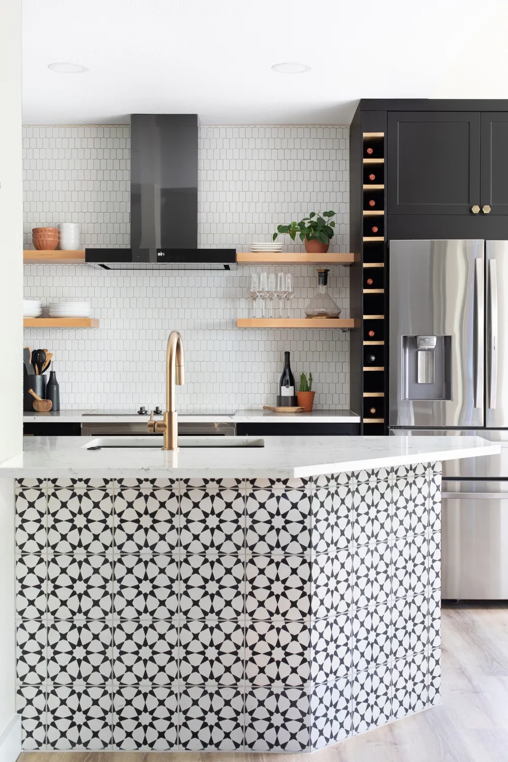 Modern Kitchen and Dining Area With Black Cabinets and Gold Accents