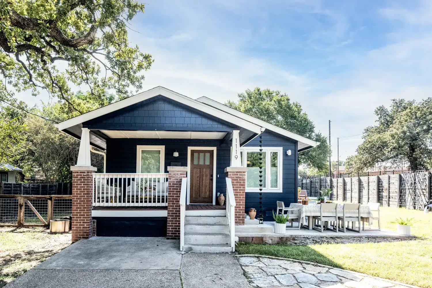 Dark Blue House With Covered Porch and White Trim