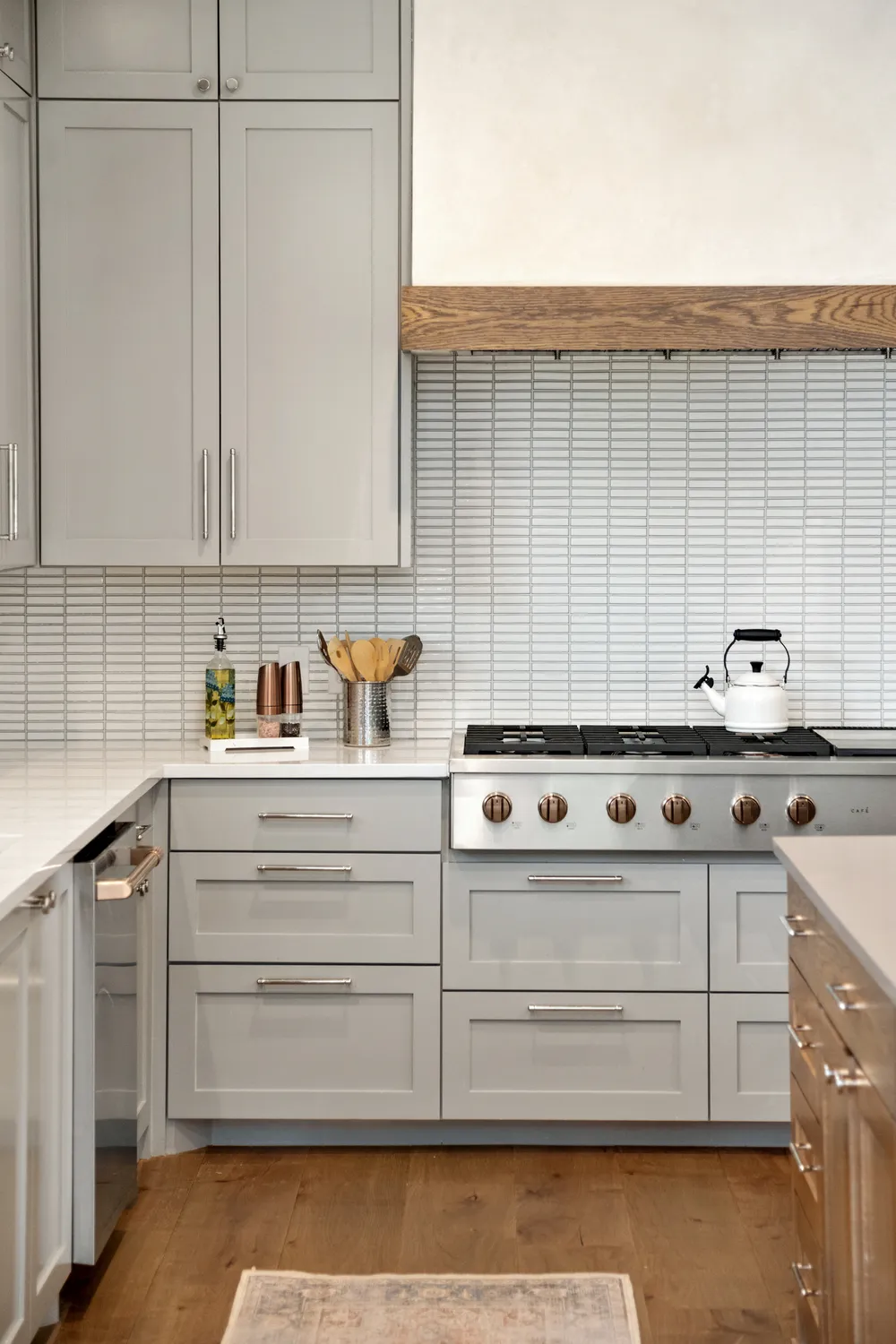 Modern Kitchen with Light Gray Cabinets and Wooden Range Hood