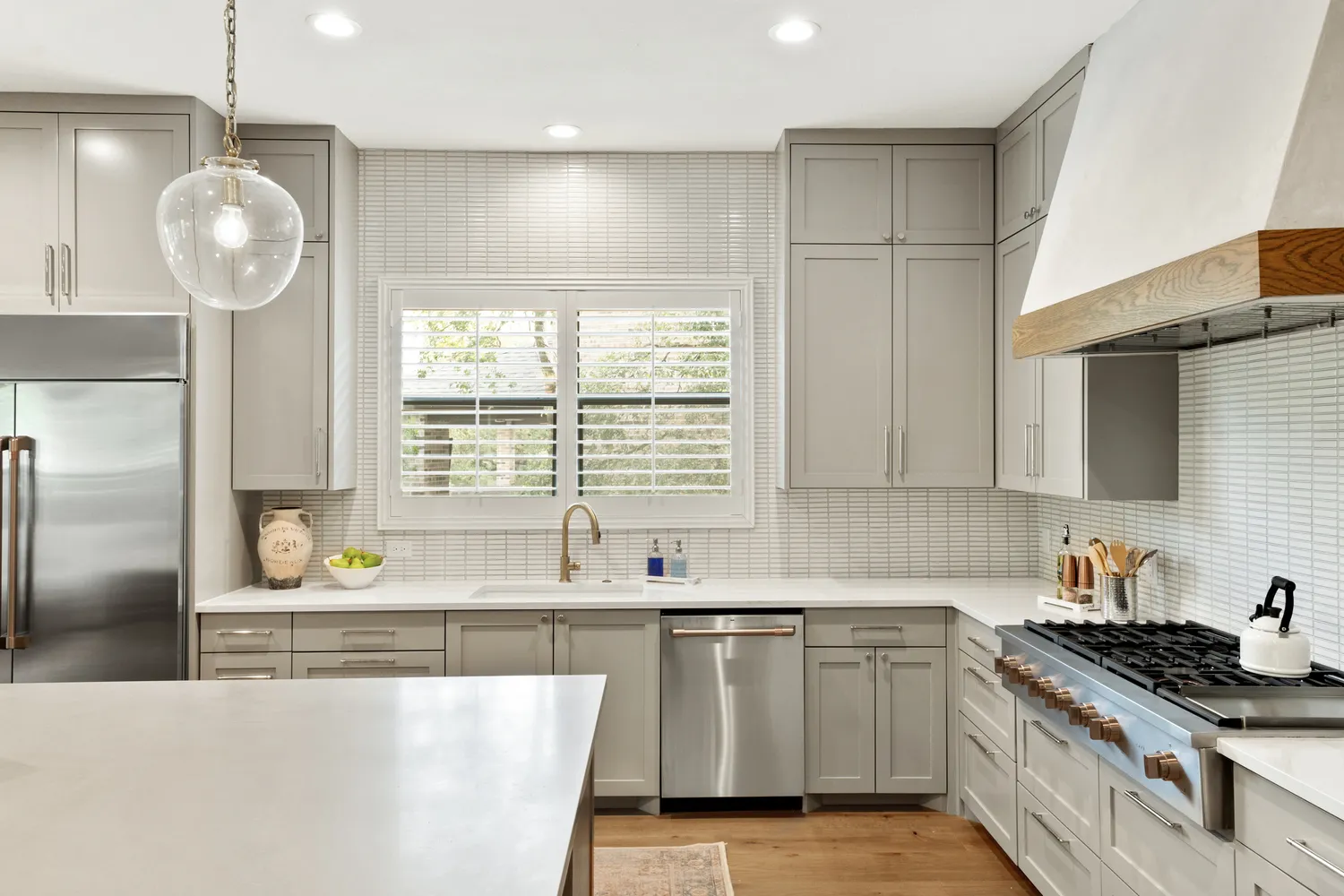 Light Gray Cabinets with White Counters and Textured Backsplash
