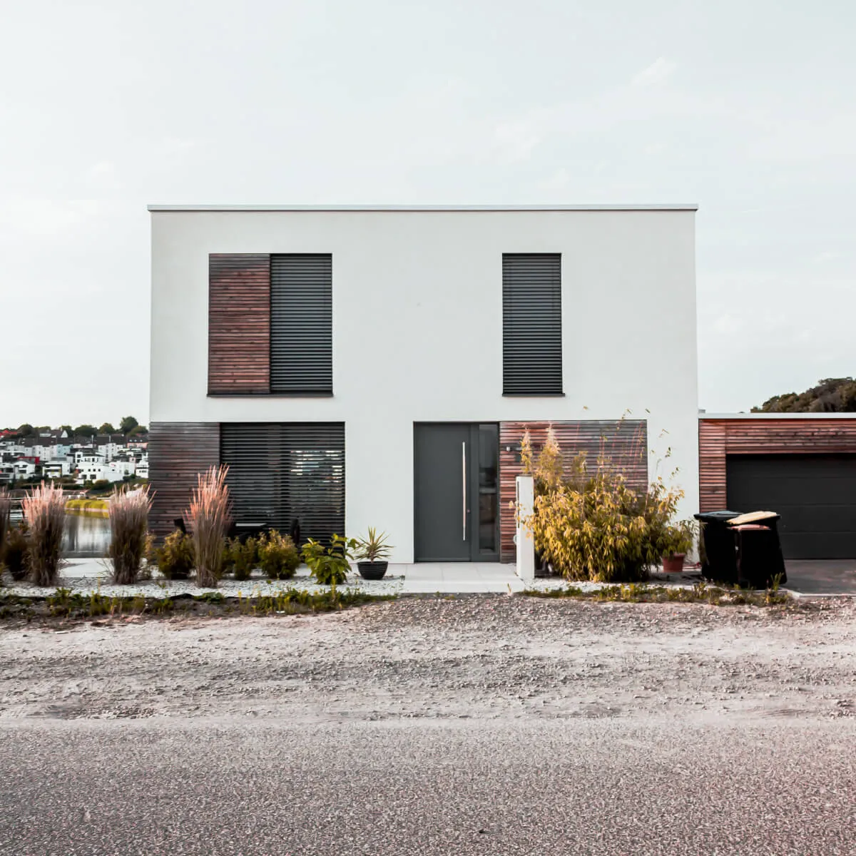 Two-story white house with wooden accents featured in a full home remodeling in Austin.