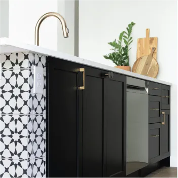 Kitchen island with black cabinets and black and white tile