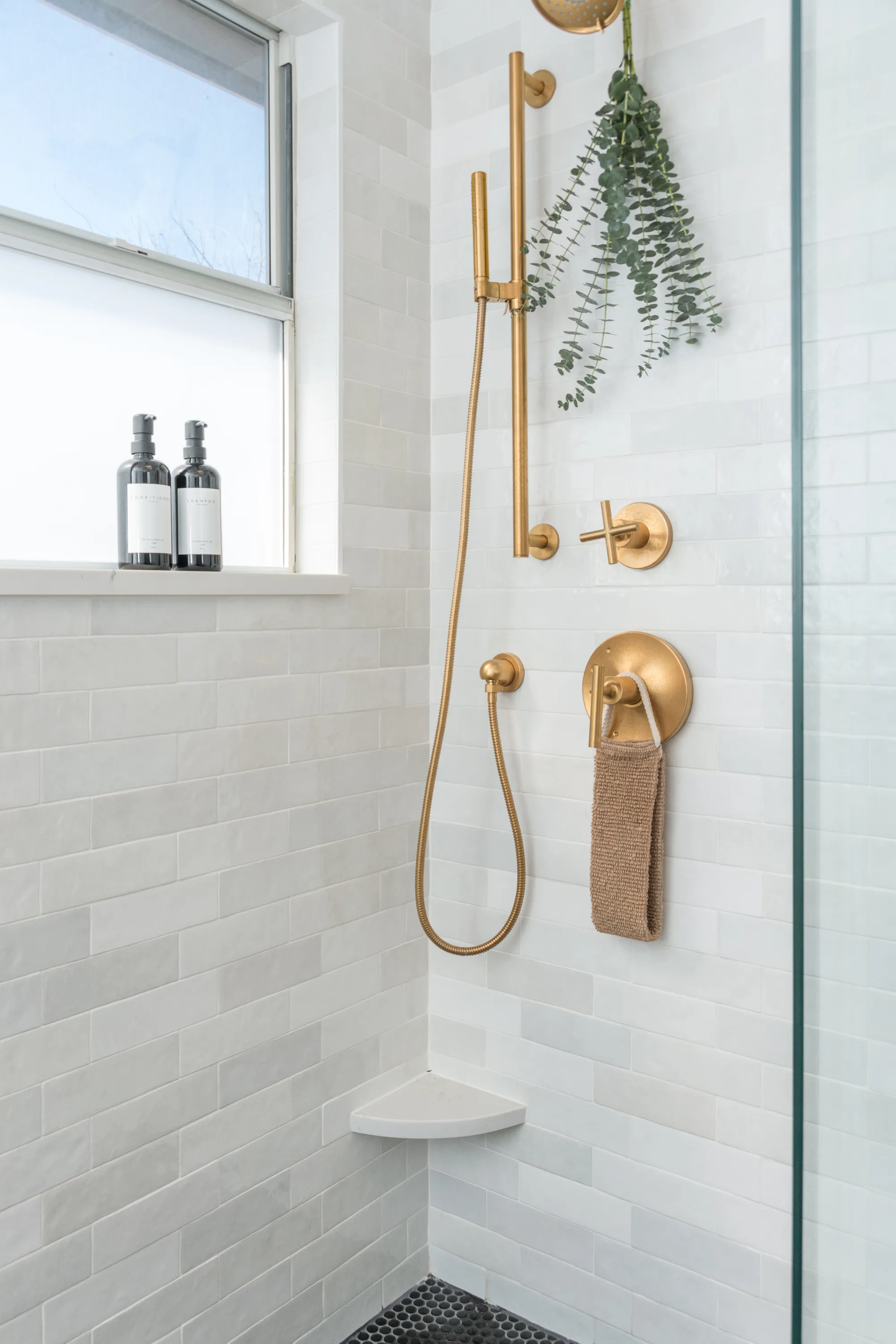 Shower with grey tile and gold shower head 