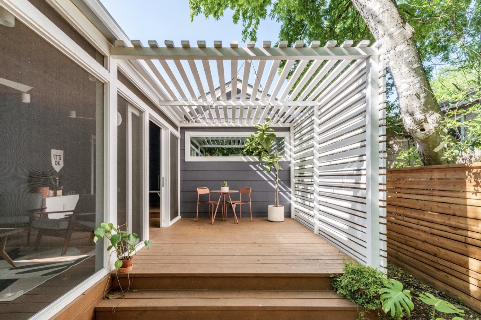 Wooden backyard patio with white slatted shade 