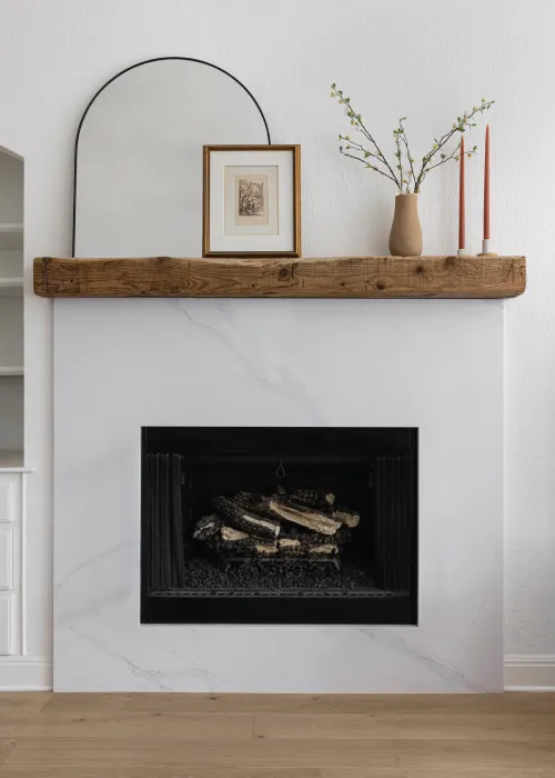 Fireplace with a wooden mantle and modern styling
