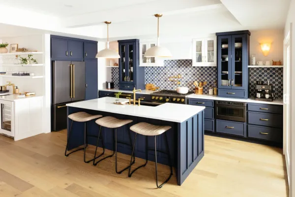 Large kitchen with blue cabinets, kitchen island, and wood floors
