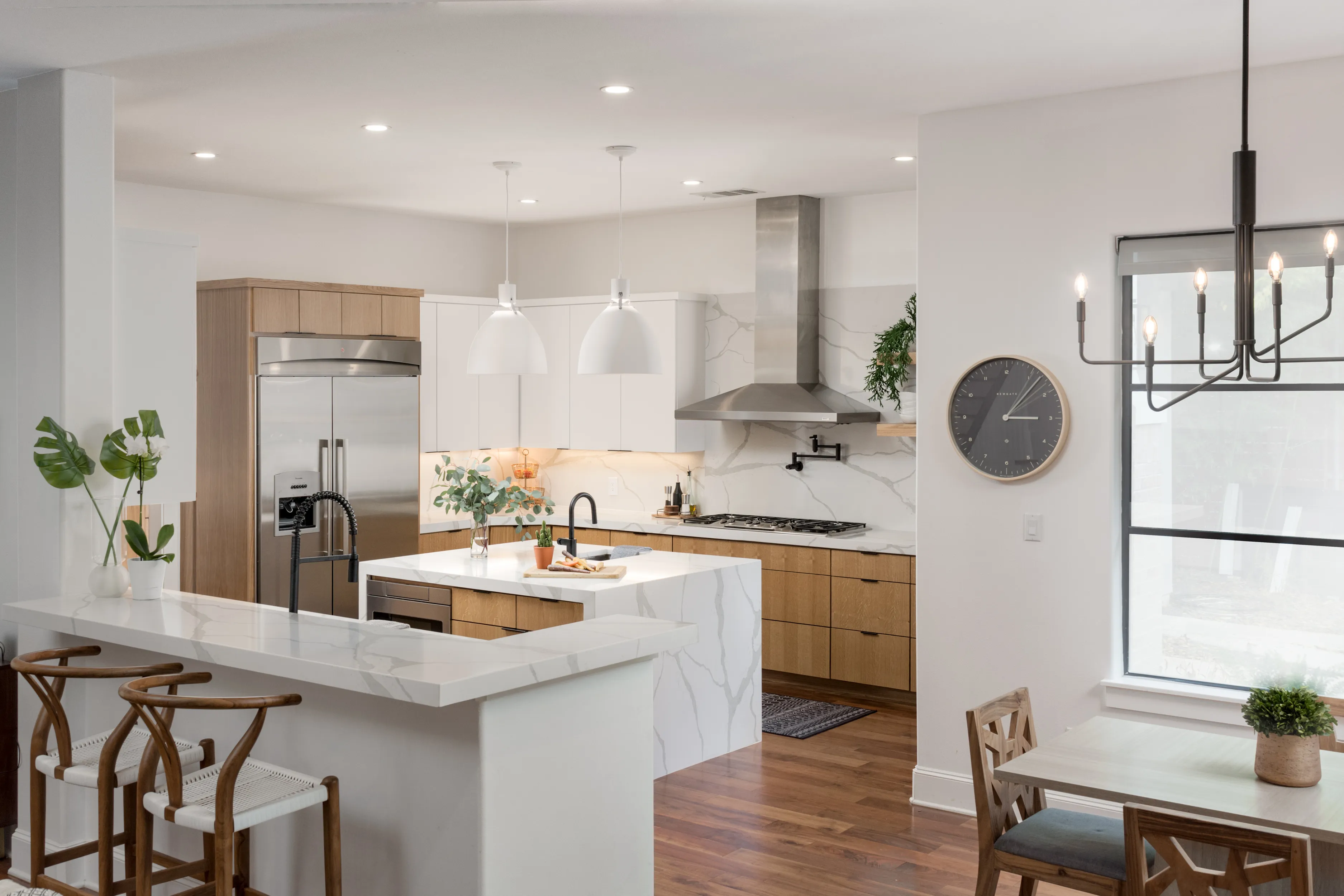 Kitchen with an island and a bar counter with chairs