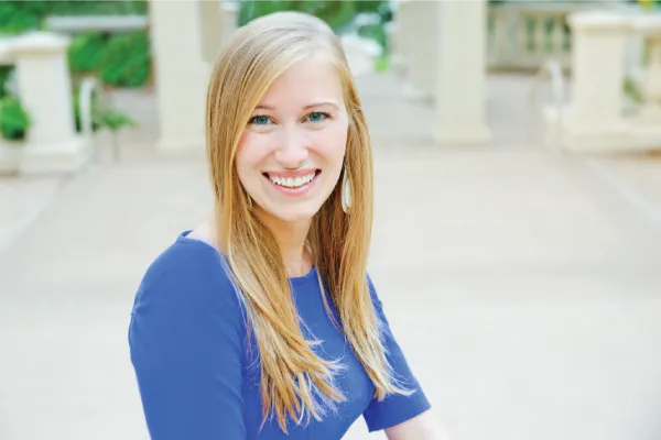 Blond women smiling in blue shirt