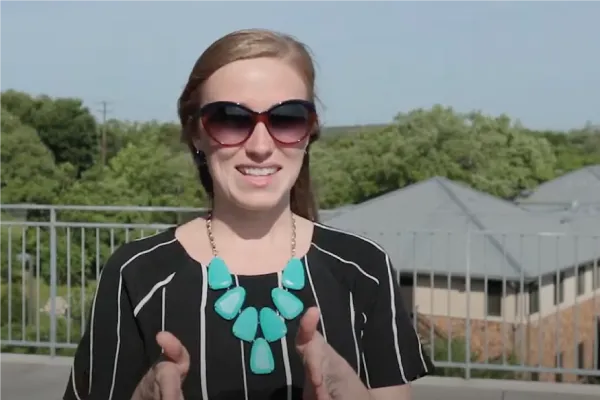 Blonde woman in sunglasses standing outside