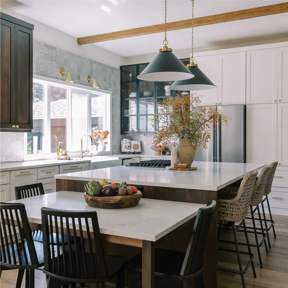 high end kitchen with an island and connected dining table 