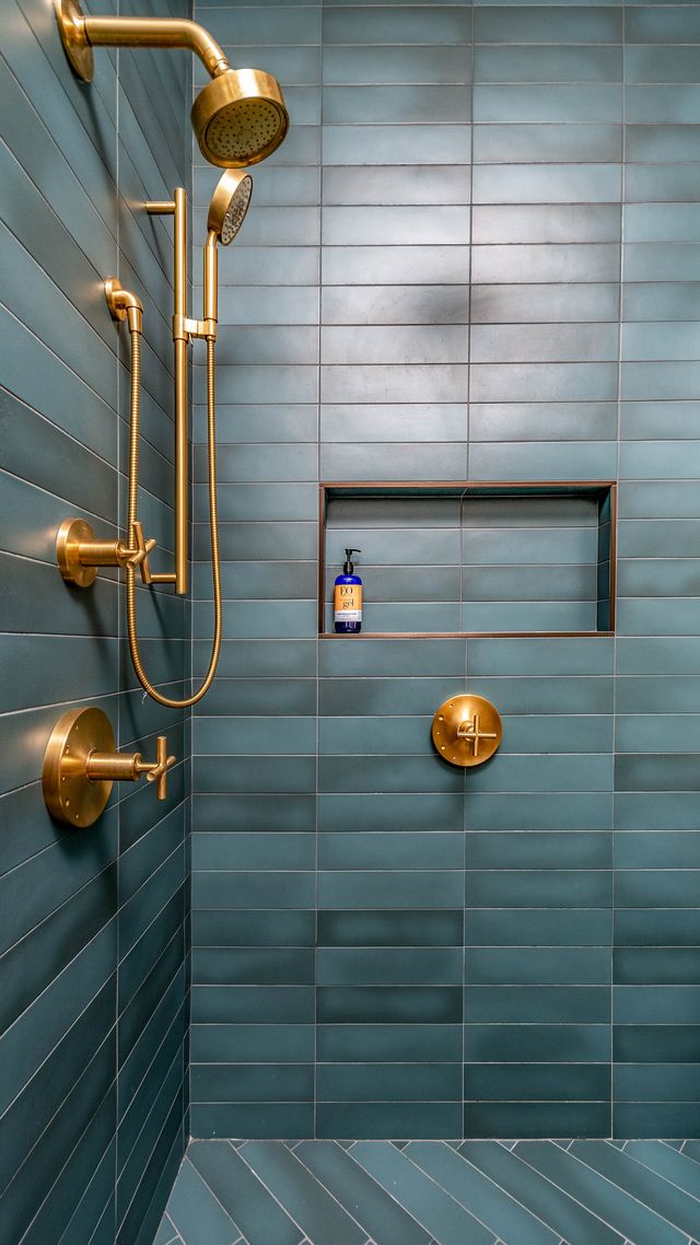 Shower with teal tile and gold fixtures