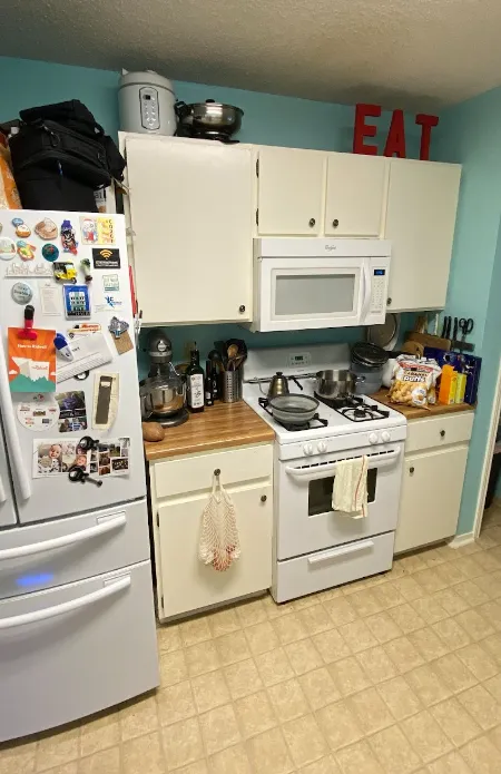 Kitchen with white appliances and blue walls 