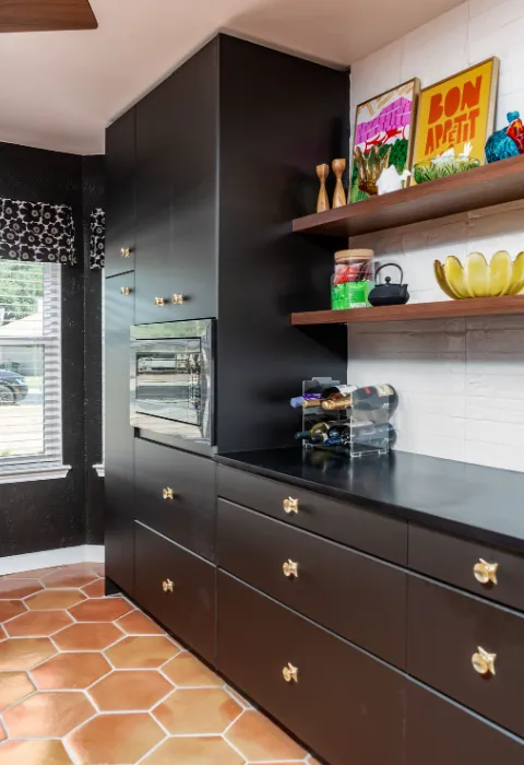 Galley style kitchen with terracotta hexagon tile flooring, dark blue cabinets, and white tile backsplash