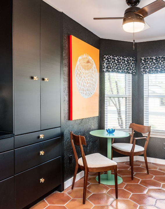 Galley style kitchen with terracotta hexagon tile flooring, dark blue cabinets, and white tile backsplash