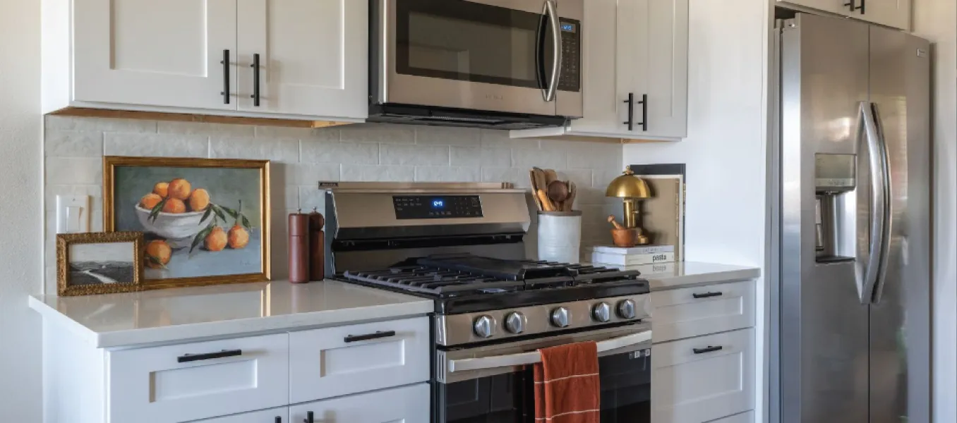 Kitchen with white cabinets, white counter tops, and white tile backsplash 