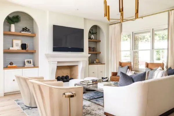 Modern high end living room with a fireplace and built-in shelving and cabinets
