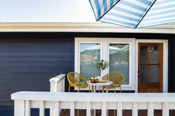 Cozy outdoor patio against a navy exterior from a full home remodeling in Austin.