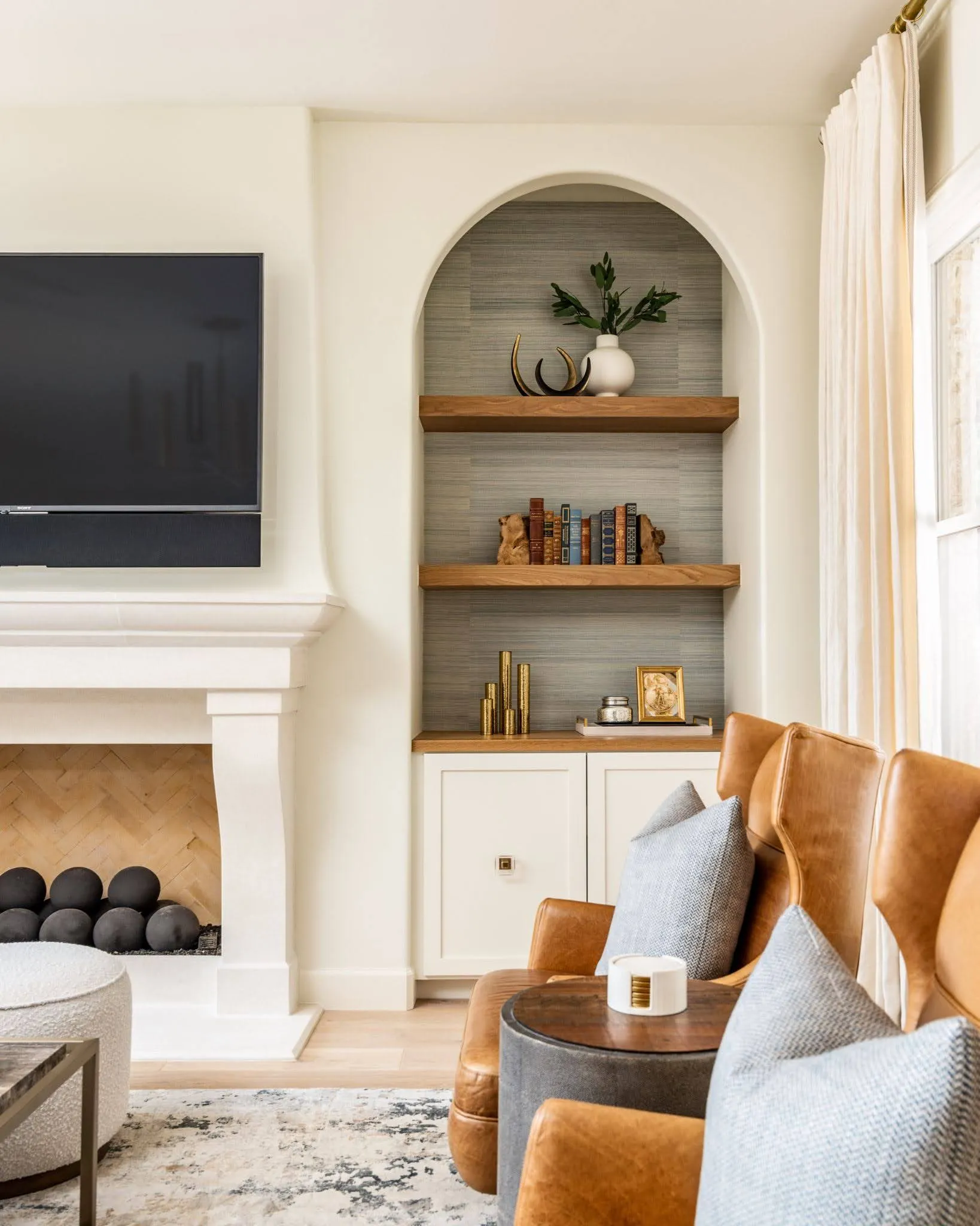 White fireplace and built-in shelves in a full home remodeling in Austin.