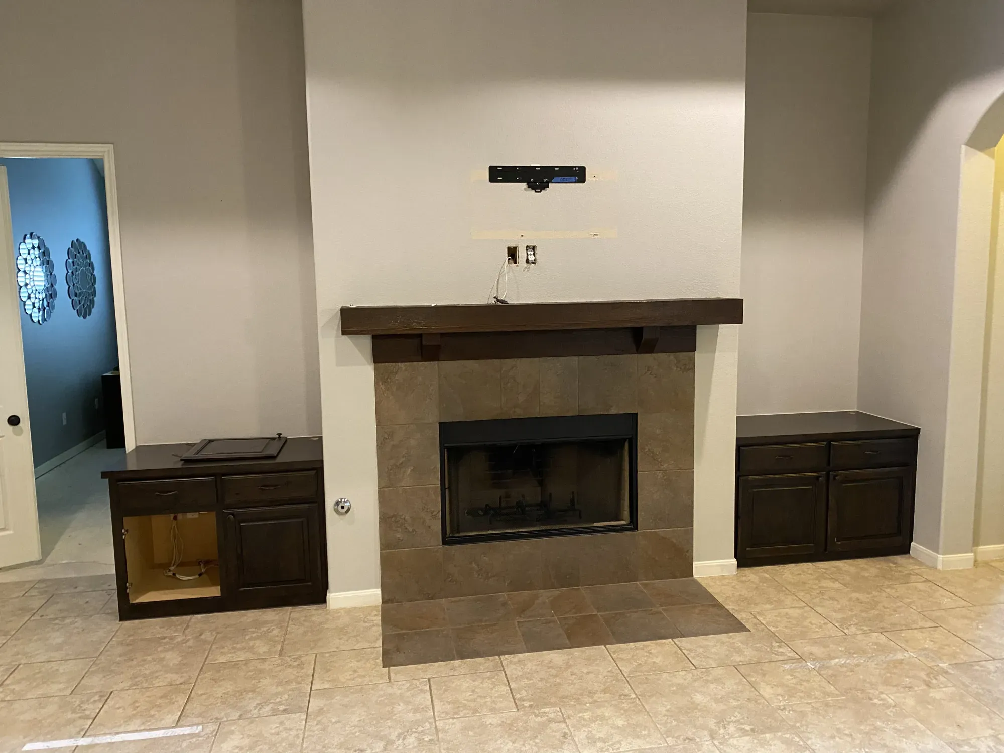 Bathroom with corner tub, granite counter, dark wood cabinets, and a wide mirror.