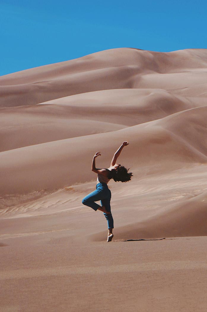 Beautiful woman dancing in the desert