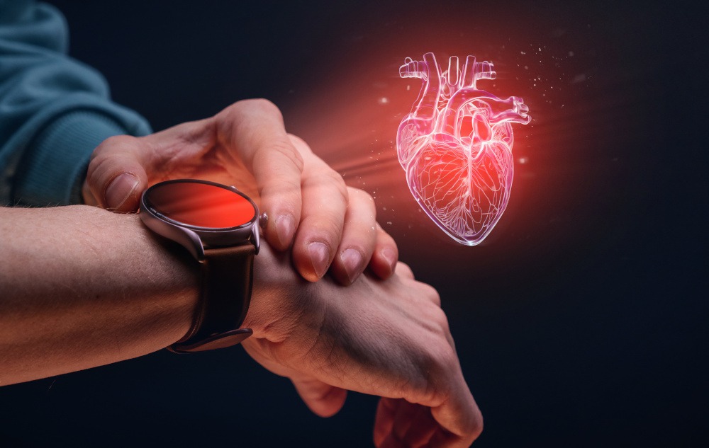 wrist watch on a mans arm showing a hologram of a real human heart 