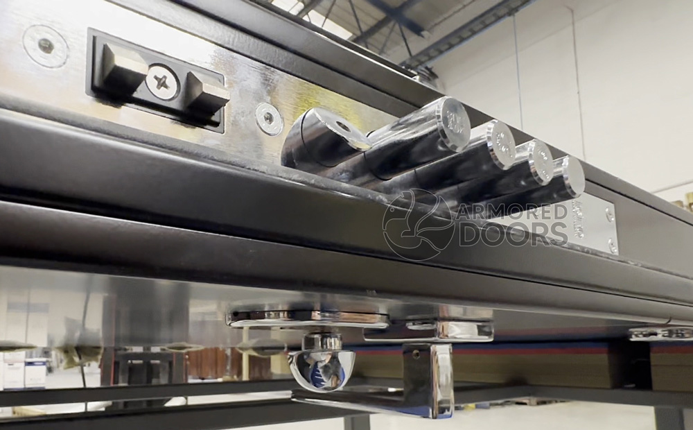 Close-up of multi-point locking bolts and reinforced steel mechanism on a security door from Armored Doors, captured during factory production.